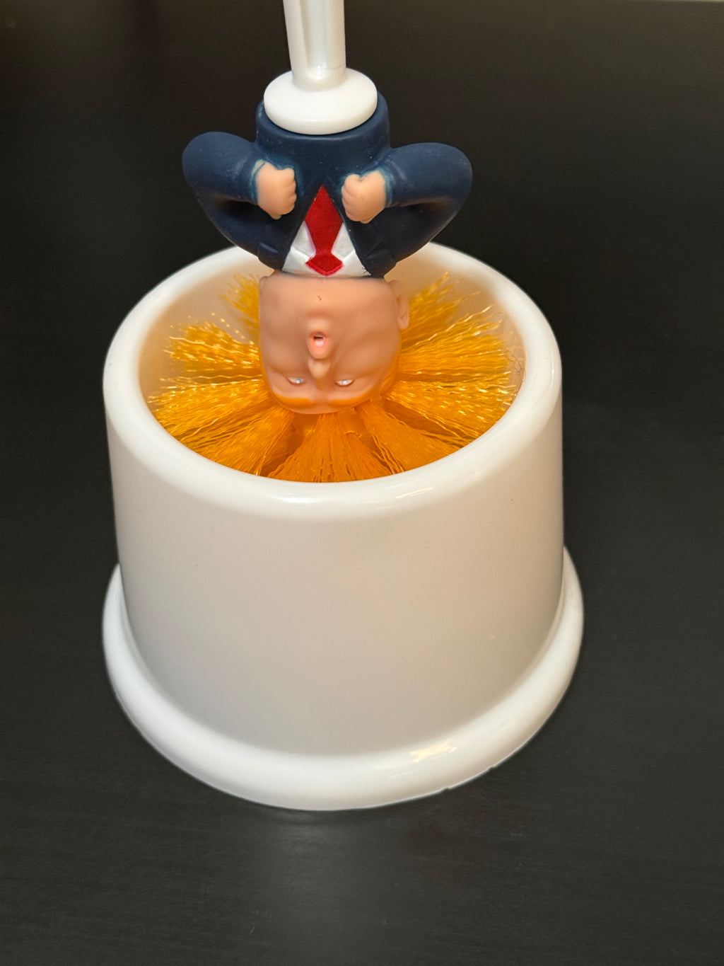 Commander in Crap™ Trump toilet brush with Limited Edition Prison Bar Bucket. When he’s not scrubbing he’s sitting in his cell.